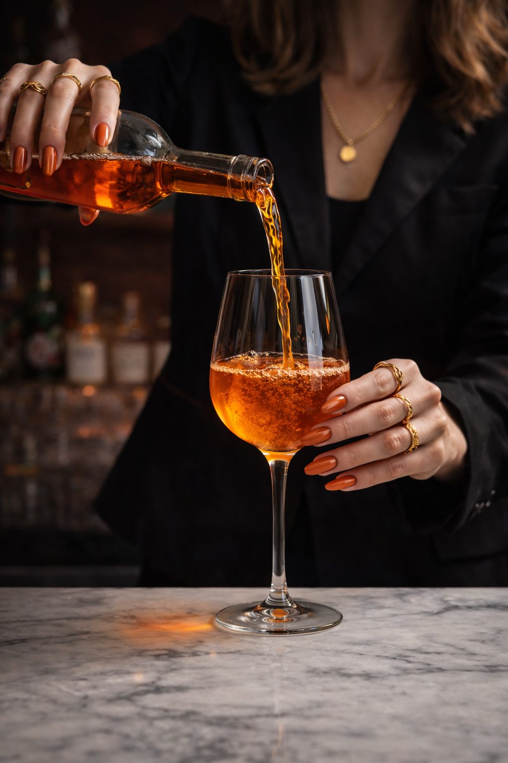 Close up of an aperitivo style wine cocktail being poured tableside at a boutique Denver wine bar