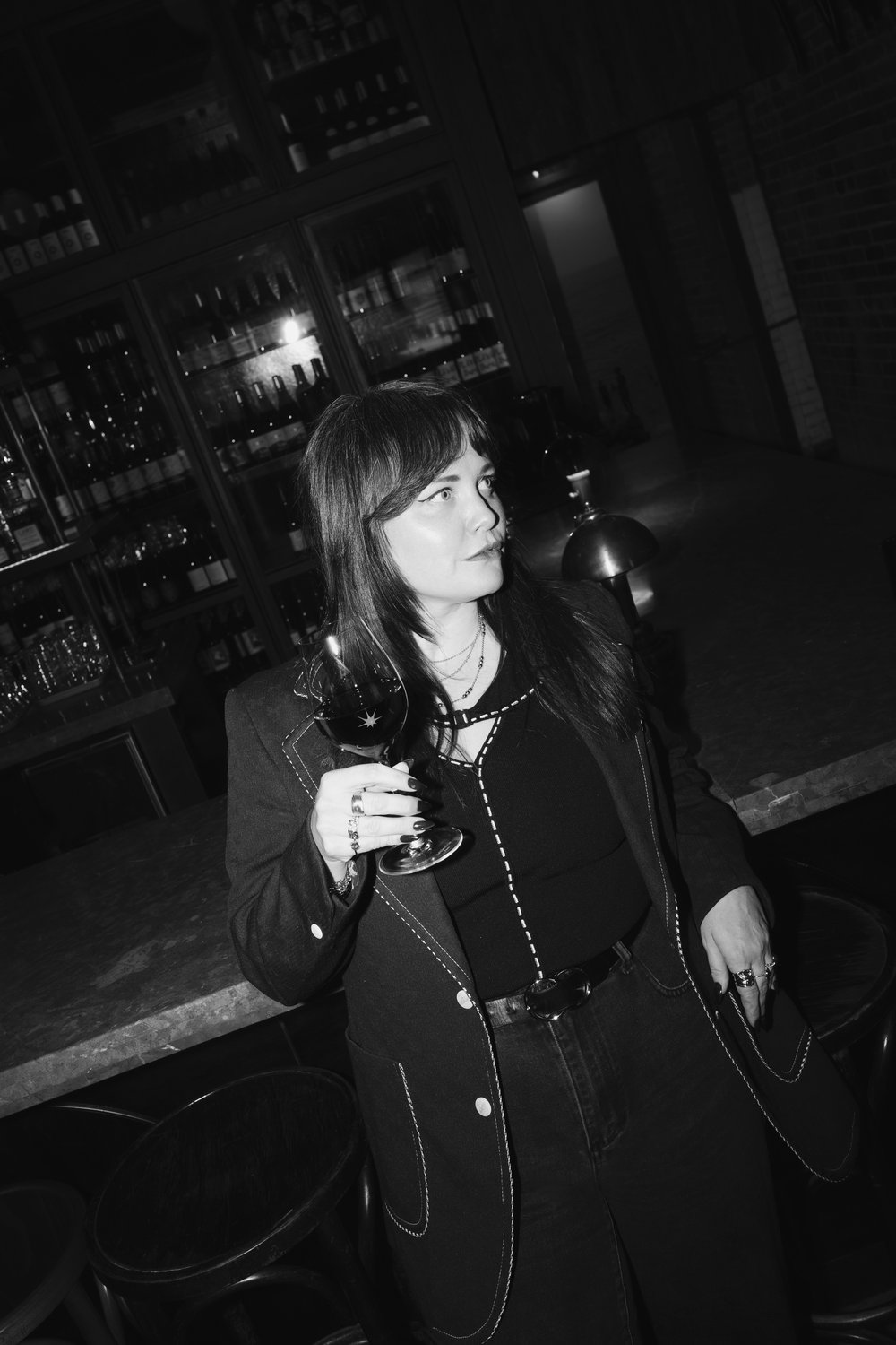 Molly Montgomery, black and white portrait at the bar